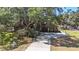 Charming home with a two-car garage and long driveway nestled among beautiful mature trees at 7157 Quail Hollow Blvd, Wesley Chapel, FL 33544