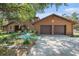 Charming log-cabin-style home with a two-car garage and well-manicured landscaping at 7157 Quail Hollow Blvd, Wesley Chapel, FL 33544