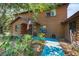 Charming log home exterior featuring a cozy front porch and attractive landscaping at 7157 Quail Hollow Blvd, Wesley Chapel, FL 33544
