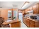 Eat-in kitchen featuring wood cabinets, stainless steel appliances, and lots of counter space at 7157 Quail Hollow Blvd, Wesley Chapel, FL 33544