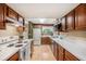 Traditional kitchen with wood cabinets, white appliances, and bright countertops at 7157 Quail Hollow Blvd, Wesley Chapel, FL 33544