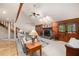 Open living room featuring a stone fireplace and beamed vaulted ceiling at 7157 Quail Hollow Blvd, Wesley Chapel, FL 33544