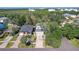 Aerial view of the home, showcasing the roof, driveway, mature trees and landscaping at 7501 S Morton St, Tampa, FL 33616