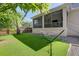The backyard has a hammock, an artificial turf lawn, and an adjacent screened-in porch at 7501 S Morton St, Tampa, FL 33616