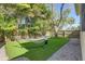 Backyard with a hammock on artificial turf, and a fenced perimeter at 7501 S Morton St, Tampa, FL 33616
