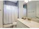 Well-lit bathroom with a stylish shower curtain and a modern vanity at 7501 S Morton St, Tampa, FL 33616