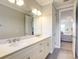 Bright bathroom featuring double sinks with white cabinets and a large mirror at 7501 S Morton St, Tampa, FL 33616