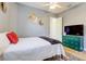 This cozy bedroom boasts a ceiling fan and a dresser with a television at 7501 S Morton St, Tampa, FL 33616