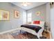 Comfortable bedroom with a cozy bed, stylish rug, and plenty of natural light at 7501 S Morton St, Tampa, FL 33616