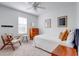 Bright bedroom with neutral decor, a ceiling fan, and a window for natural light at 7501 S Morton St, Tampa, FL 33616