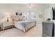 This bedroom offers a luxurious bed, and two bedside tables with reading lamps at 7501 S Morton St, Tampa, FL 33616