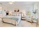 This bedroom features a spacious bed, side tables with lamps, and a cozy armchair at 7501 S Morton St, Tampa, FL 33616