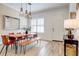Bright dining area featuring wood flooring, a modern table set, and lots of natural light at 7501 S Morton St, Tampa, FL 33616