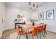 Stylish dining room with a wooden table, seating for six, pendant lights, and decorative wall art at 7501 S Morton St, Tampa, FL 33616
