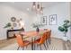 Stylish dining room with a wooden table, seating for six, pendant lights, and decorative wall art at 7501 S Morton St, Tampa, FL 33616