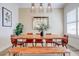 Stylish dining room with a natural wood table, bench, modern lighting, and elegant decor at 7501 S Morton St, Tampa, FL 33616