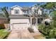 Charming two-story home with neutral paint, stone accents, attached two-car garage and landscaped yard at 7501 S Morton St, Tampa, FL 33616