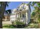 Beautiful home with a stone archway, shutters, landscaping, and a two-car garage at 7501 S Morton St, Tampa, FL 33616
