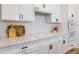 Close up shot of the kitchen countertops with modern appliances, white subway tile, and white cabinets at 7501 S Morton St, Tampa, FL 33616