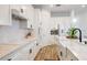 Bright kitchen with white cabinets, modern appliances, and expansive countertops for food preparation at 7501 S Morton St, Tampa, FL 33616