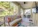 Spacious screened porch features comfortable seating and views of the surrounding greenery at 7501 S Morton St, Tampa, FL 33616