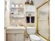 Bathroom boasts vanity, toilet, bathtub, and shower with glass doors at 7703 W Hiawatha St, Tampa, FL 33615