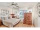 Comfortable bedroom with hardwood floors, mirrored wall, and cozy decor at 7703 W Hiawatha St, Tampa, FL 33615