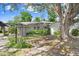 Charming single-story home featuring a covered driveway, well-maintained landscaping and a large tree at 7703 W Hiawatha St, Tampa, FL 33615