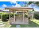 Charming wood gazebo in the backyard, offering a tranquil retreat surrounded by lush greenery at 7703 W Hiawatha St, Tampa, FL 33615