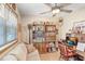 Bright home office featuring hardwood floors, comfortable seating and built-in bookshelves at 7703 W Hiawatha St, Tampa, FL 33615