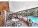 Relaxing screened-in patio features wood walls, a ceiling, and overlooks the sparkling pool at 7703 W Hiawatha St, Tampa, FL 33615