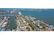 Expansive aerial shot reveals the home's proximity to the water and the vibrant coastal community at 7919 Causeway S Blvd, St Petersburg, FL 33707