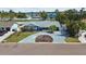 Inviting curb appeal with a well-maintained lawn, mature landscaping, and a circular driveway at 7919 Causeway S Blvd, St Petersburg, FL 33707