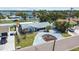 Elevated aerial view of a single-story home with a circular driveway and mature landscaping at 7919 Causeway S Blvd, St Petersburg, FL 33707