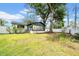 This home has a large backyard that includes a fence and mature shade trees at 8115 N Ola Ave, Tampa, FL 33604