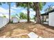This backyard has a storage shed, a fence, mature shade trees, and room for gardening at 8115 N Ola Ave, Tampa, FL 33604