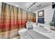 Bathroom featuring neutral tile flooring, a shower-tub combo, and white vanity at 8115 N Ola Ave, Tampa, FL 33604