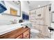 Bathroom featuring a modern sink and vanity with wood cabinets and stylish mirror at 8115 N Ola Ave, Tampa, FL 33604