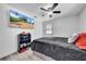 This bedroom features an installed television, fan, and wood-look flooring at 8115 N Ola Ave, Tampa, FL 33604