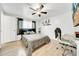 Bedroom features a ceiling fan, hardwood floors, and black out curtains at 8115 N Ola Ave, Tampa, FL 33604