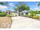 Charming single-story home featuring a well-maintained lawn and long driveway at 8115 N Ola Ave, Tampa, FL 33604