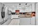 Bright kitchen features white cabinetry, granite countertops, and stainless steel appliances at 8115 N Ola Ave, Tampa, FL 33604