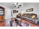 This living room features wood floors, a ceiling fan, leather sofas, and modern decor at 8115 N Ola Ave, Tampa, FL 33604