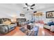 This living room is equipped with a ceiling fan, a view of the backyard, and leather furniture at 8115 N Ola Ave, Tampa, FL 33604