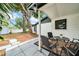 Relaxing outdoor patio features trees offering shade and serene backyard views at 8115 N Ola Ave, Tampa, FL 33604