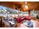 This bright sunroom has wood paneling, clay tile floors, and a view of the backyard at 8115 N Ola Ave, Tampa, FL 33604