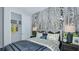 This bedroom features a comfortable bed, spacious closet, and peaceful wooded themed wall at 819 Steel Dr, Apollo Beach, FL 33572