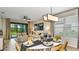 Formal dining area featuring modern decor and plenty of natural light, adjacent to an inviting living room at 819 Steel Dr, Apollo Beach, FL 33572