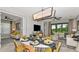 Stylishly decorated dining room with modern light fixtures, and seamlessly connects to the living area at 819 Steel Dr, Apollo Beach, FL 33572
