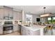 Well-equipped kitchen featuring a stainless steel appliance suite, light cabinets and quartz countertops at 819 Steel Dr, Apollo Beach, FL 33572